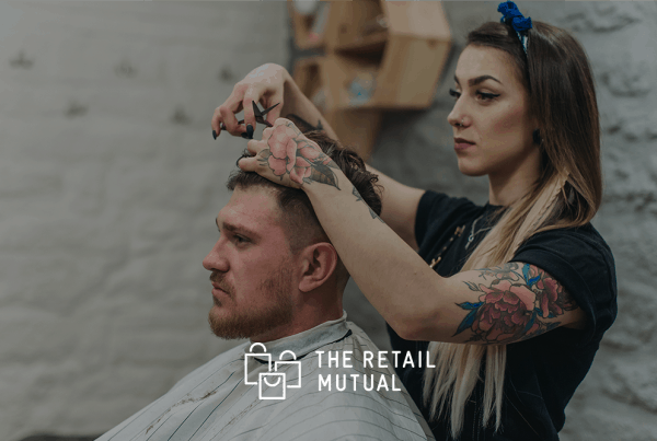 lady cutting a mans hair in a barbers